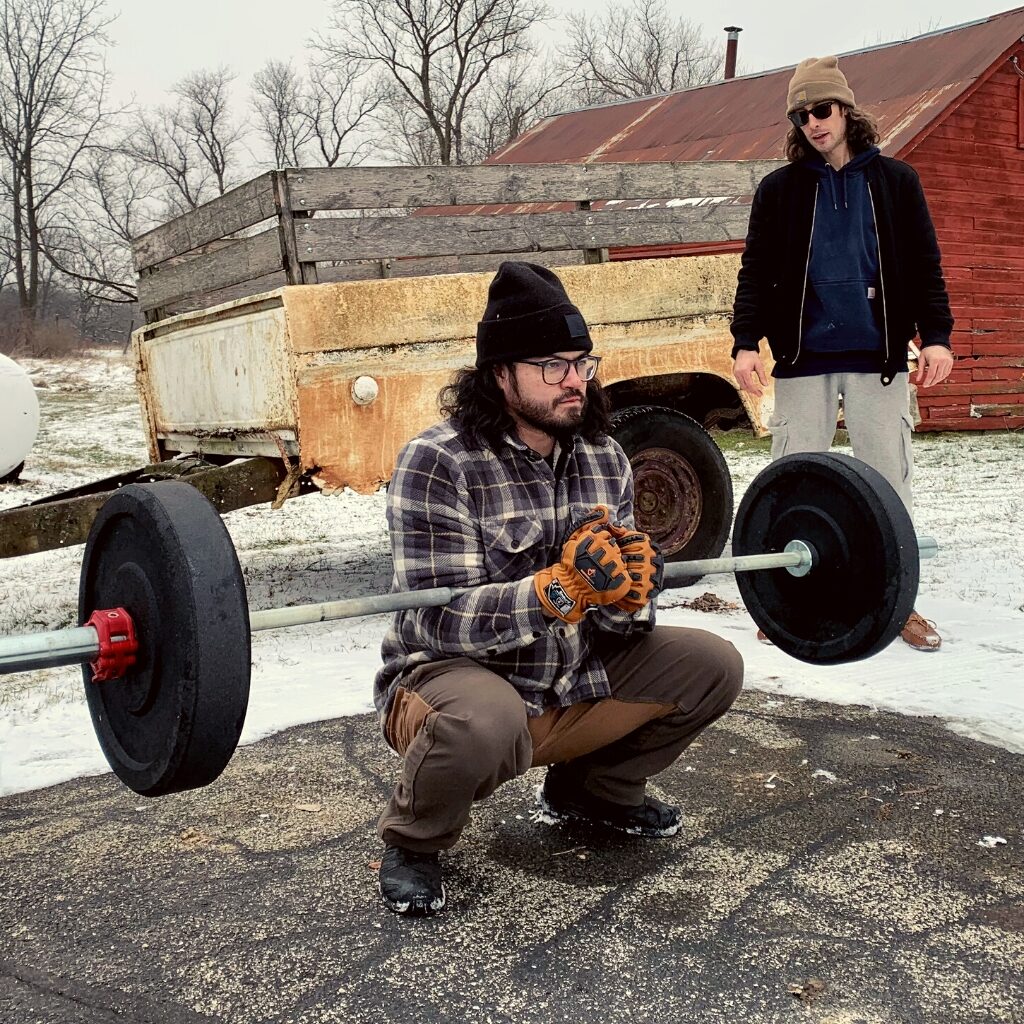 young man working out with personal trainer outdoors in rockford, il